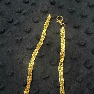 Gold plated. It’s fairly heavy, beautiful sparkly. 18 inch